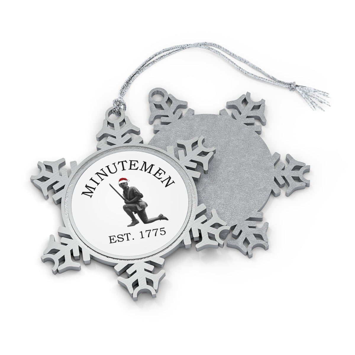 Minuteman pewter snowflake ornament, front and back — kneeling minute man statue with Santa hat medallion, Est. 1775, silver cord