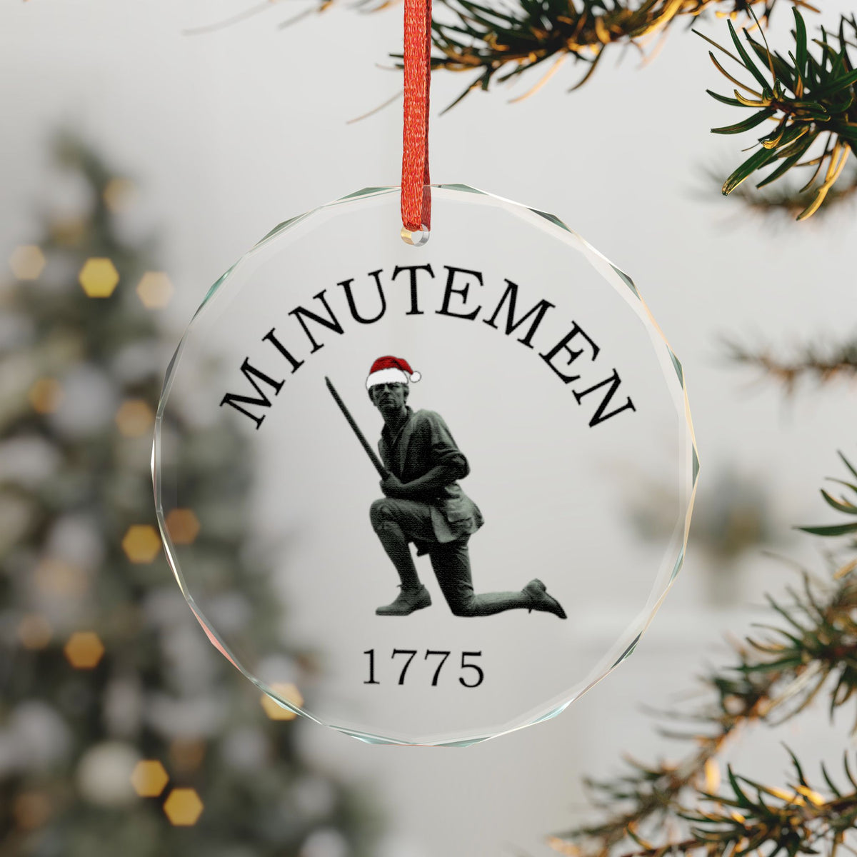 Minuteman Crystal Glass Ornament on a Christmas Tree, Kneeling Minute Man Statue in a Santa Hat